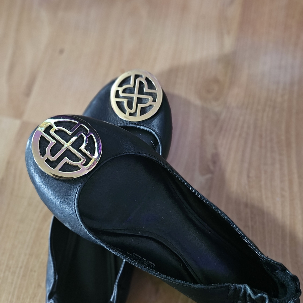 Chic Black Flats with Gold Emblem